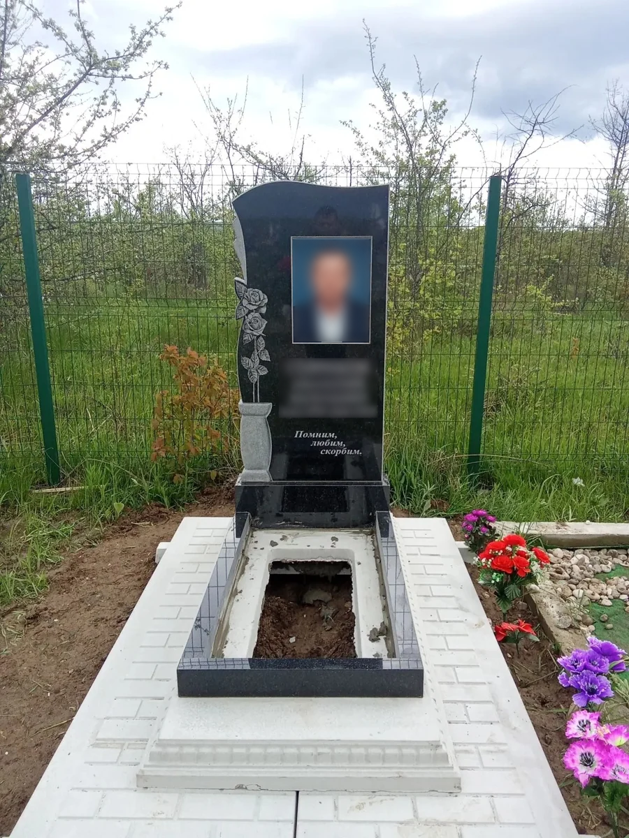 Памятник и цветник на мощёной площадке